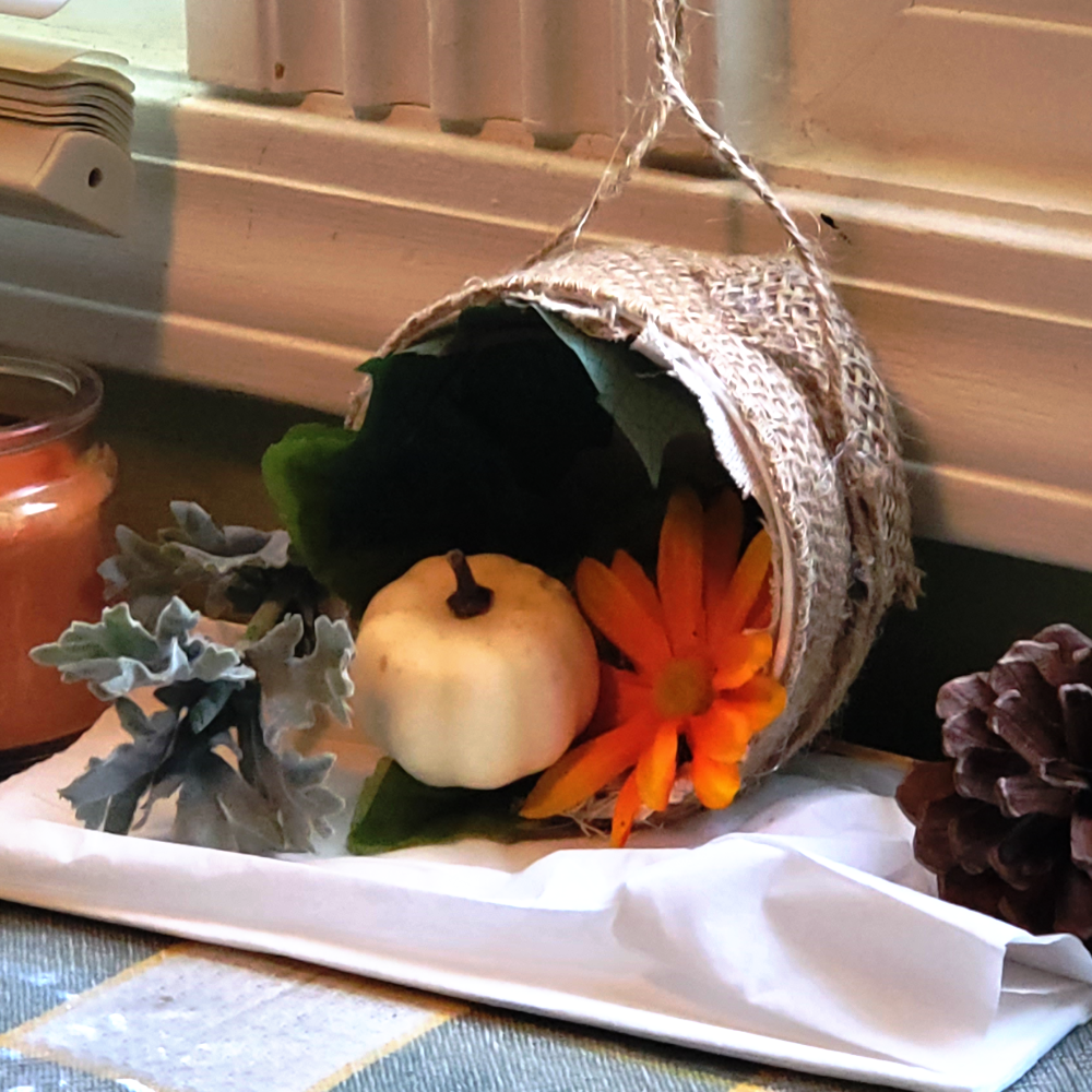 Boho, recycled, fall-inspired wall décor made out of a plastic container