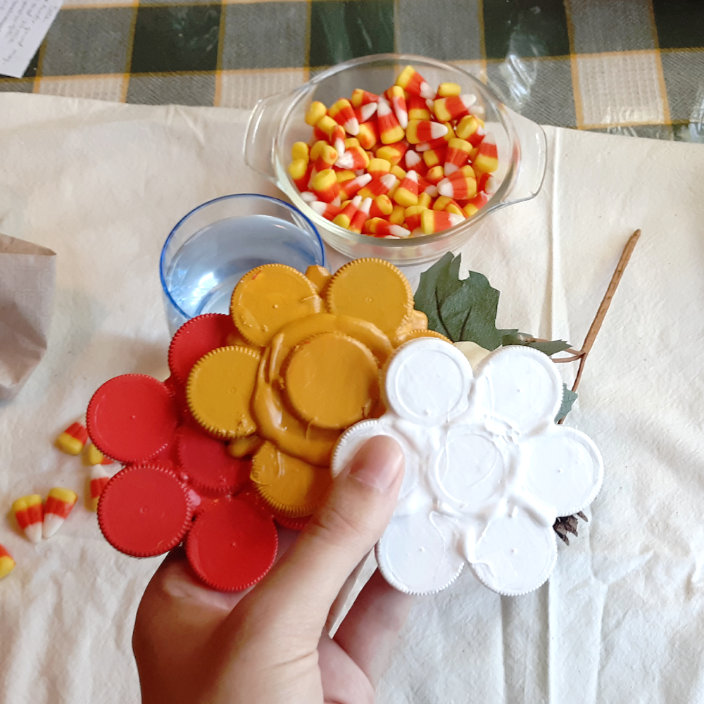 Candy corn-inspired drink coasters made out of recycled bottle caps